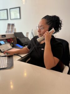 front desk staff taking a phone call