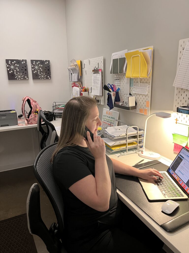 Amber taking a patient phone call