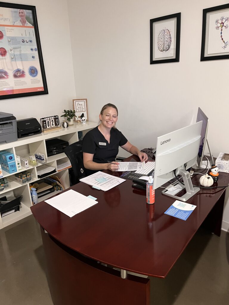 Amber working at her desk doing billing